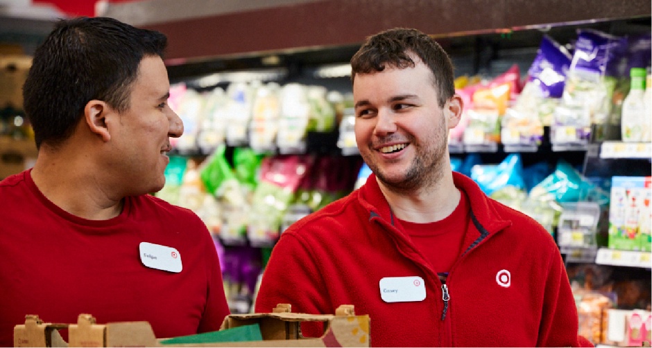 Target team members talking in a grocery aisle.