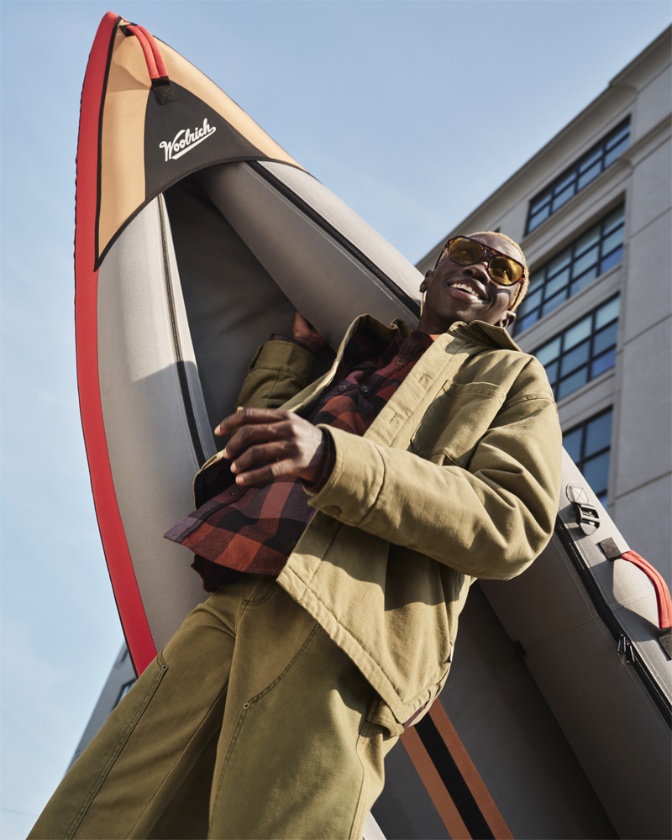 Model styled with pieces including the inflatable kayak from the Woolrich x Target collection