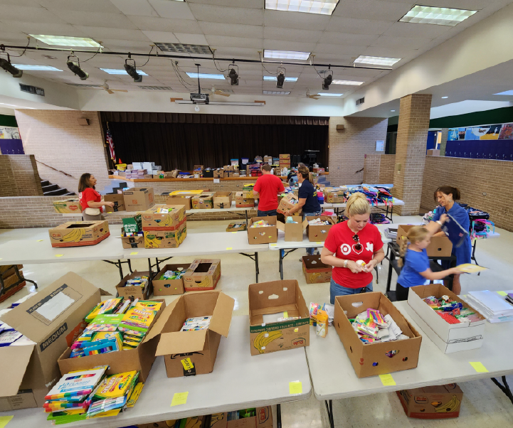 a group of people in a room with boxes