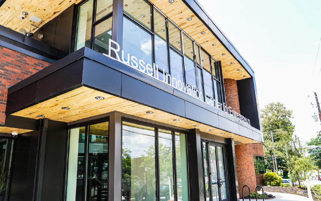 The exterior of the Russell Innovation Senter for Entrepreneurs, a brick building with expansive windows.