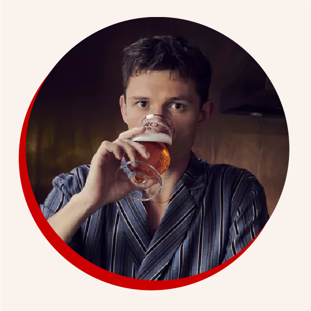 Tom Holland sipping from a glass of BERO beer and an inset image of a can of BERO beer.